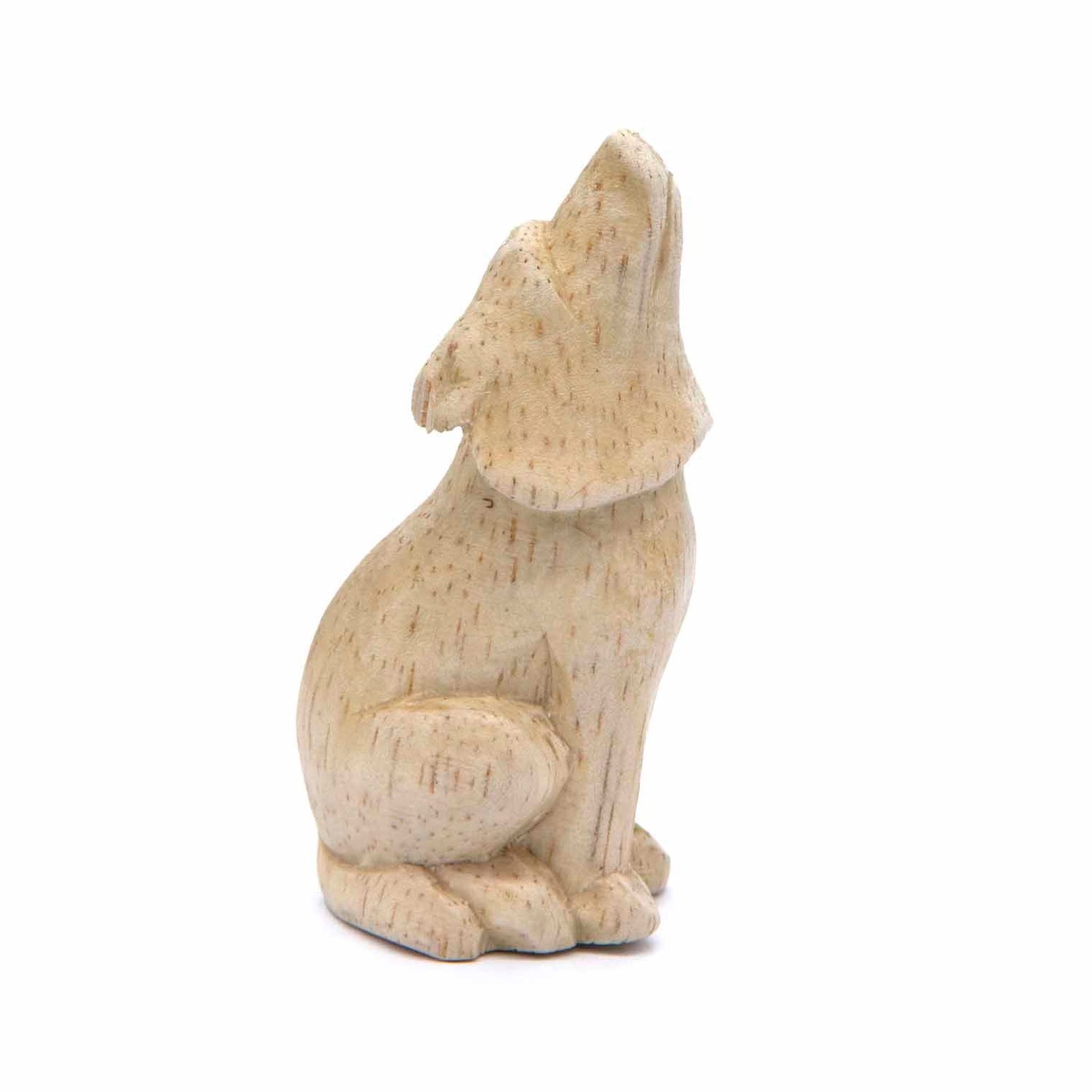 Mini pale wood howling wolf carving, side view showing head tipped back and upright posture