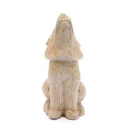 Small carved wolf figurine, rear view showing smooth pale wood body and ear detail, Indonesia