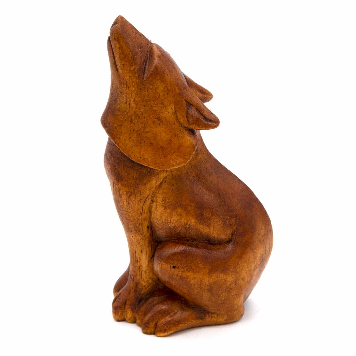 Medium howling wolf wood carving, side view showing seated posture and warm grain, Indonesia