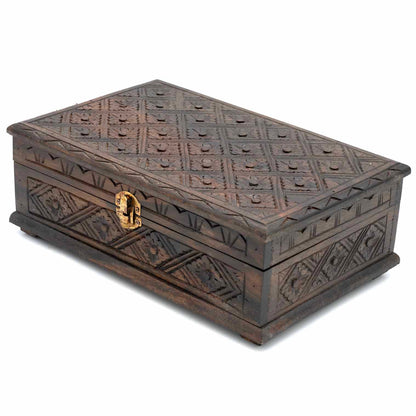 Three-quarter front view of dark carved jewellery box, lid slightly angled to show depth of relief pattern