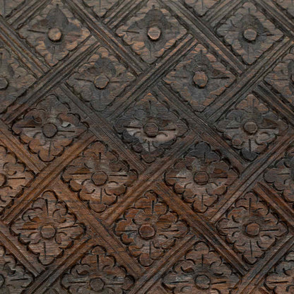 Macro detail of diamond-and-flower relief carving on the lid of the Indonesian wooden jewellery box