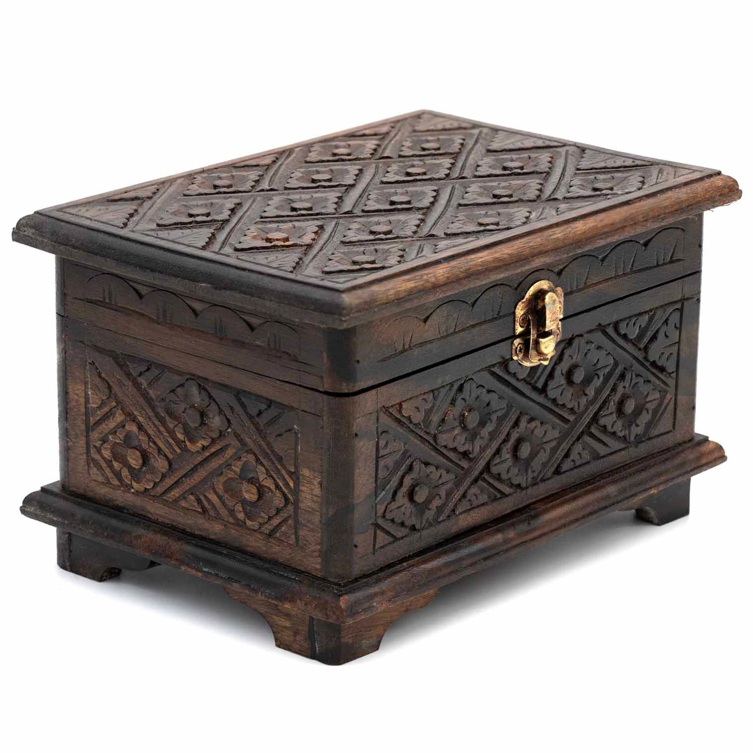 Three-quarter view of dark carved wooden jewellery chest showing relief pattern across lid and all four sides