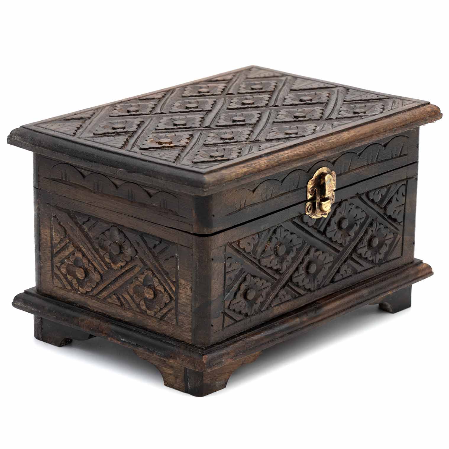 Three-quarter view of dark carved wooden jewellery chest showing relief pattern across lid and all four sides