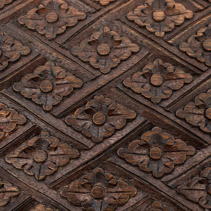 Macro detail of diamond-and-flower relief carving on the lid of the Indonesian wooden jewellery chest