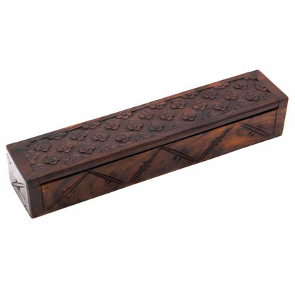 Long narrow carved wood box closed, three-quarter view showing flower-grid lid and lattice-carved sides, Indonesia