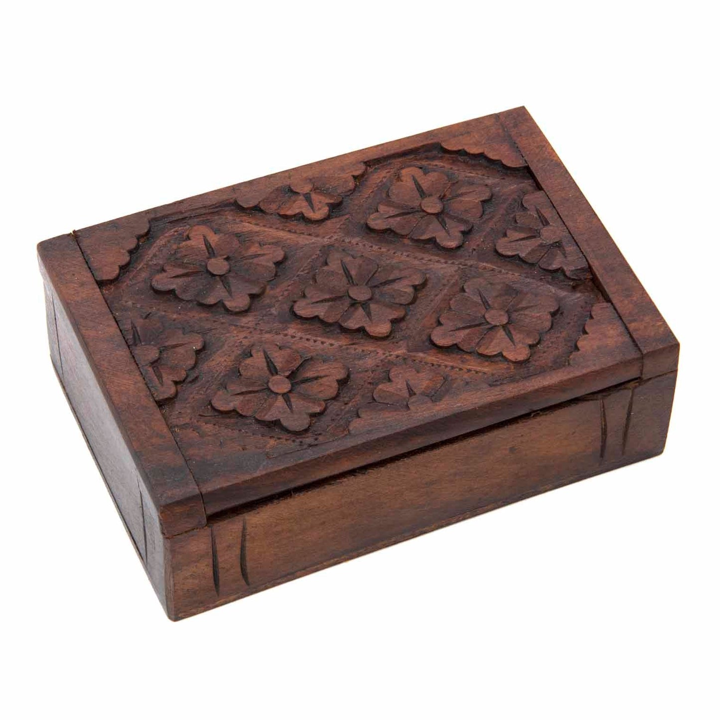 Top view of carved wood playing card box with four-flower grid relief on lid, white background