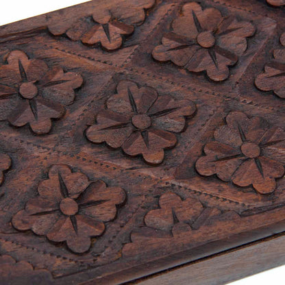 Close-up of hand-chisel flower relief carving on the lid of the Indonesian wooden playing card box