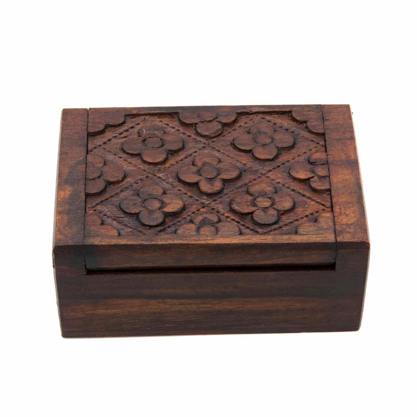 Top-down view of mini carved wood box showing flower-and-diamond relief pattern across the full lid surface
