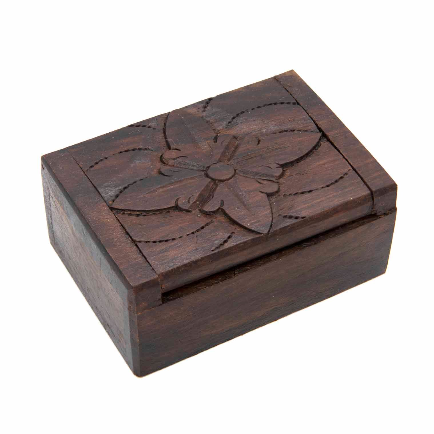 Small carved wooden box with single large flower motif on lid, three-quarter view on white background