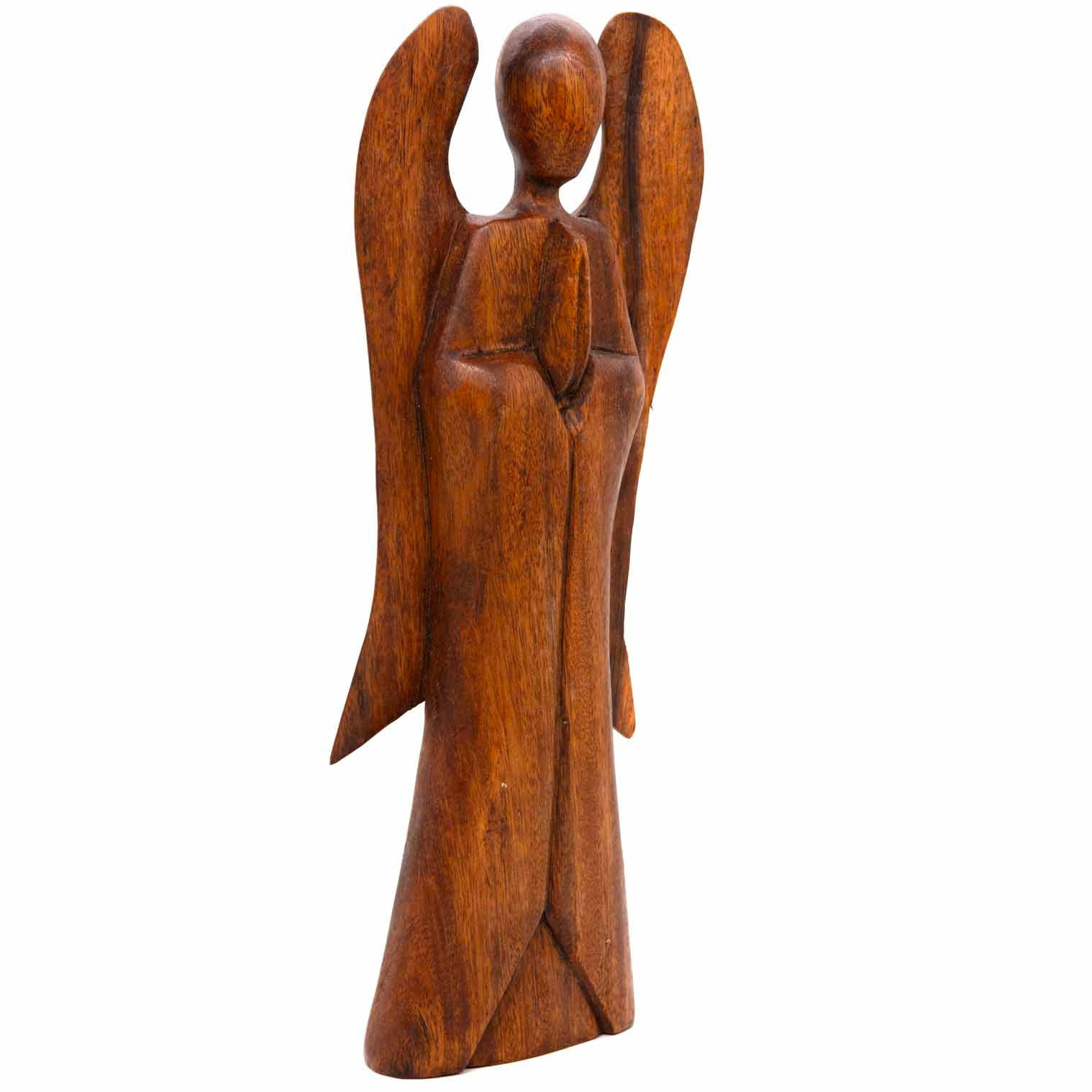 Three-quarter view of 40cm abstract wooden angel carving showing wing depth and grain, Indonesia