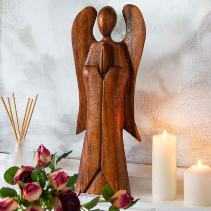 40cm abstract wooden angel carving on a mantelpiece with roses and candles, front view, Indonesia