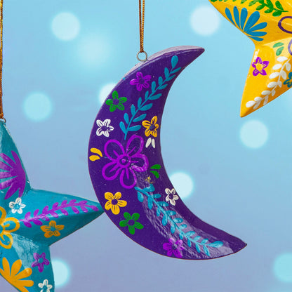 Purple hand-painted wood crescent moon hanging with colourful floral motifs, Bali Indonesia, among other decorations