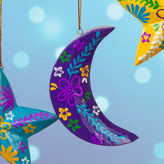 Purple hand-painted wood crescent moon hanging with colourful floral motifs, Bali Indonesia, among other decorations