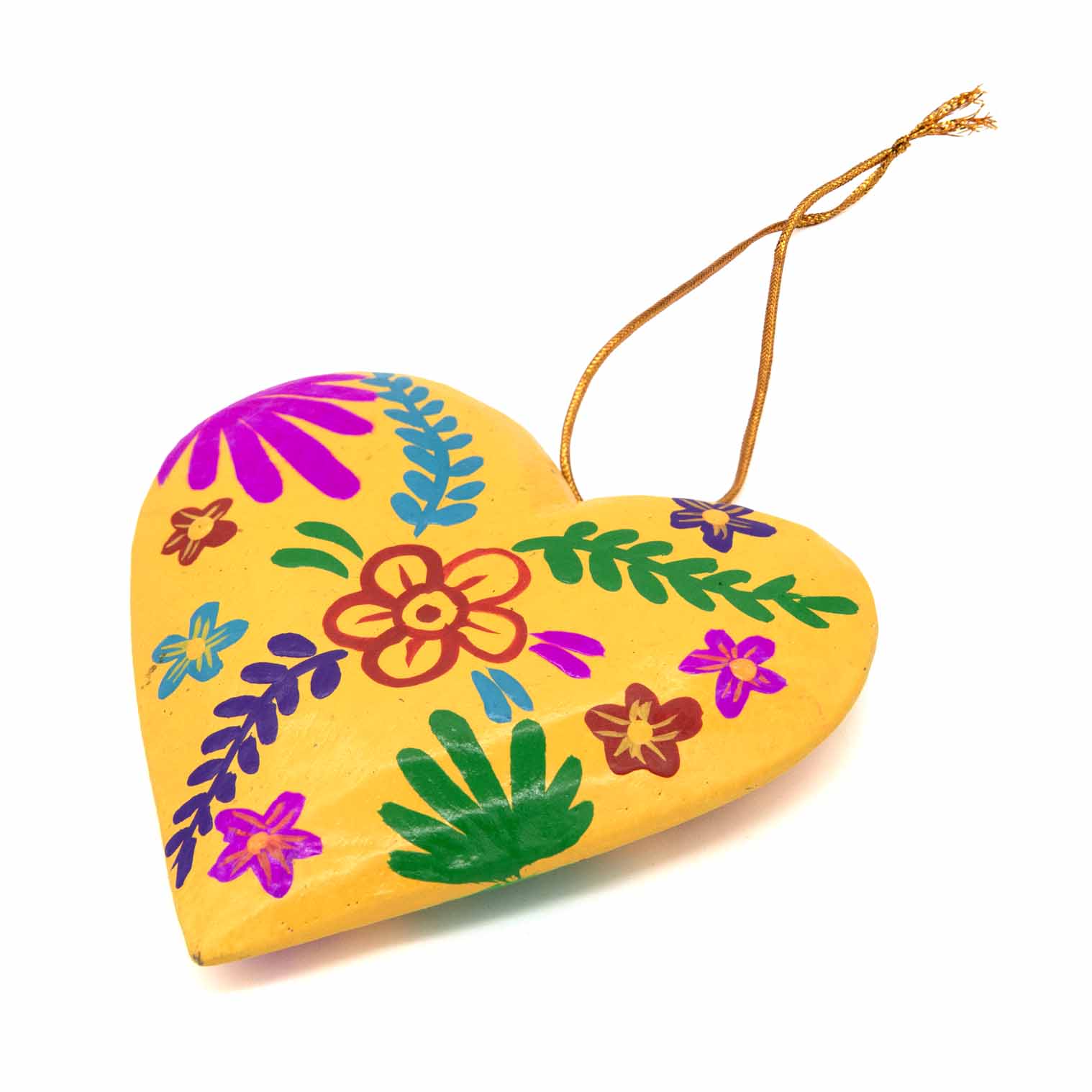 Yellow hand-painted wood heart, angled view showing domed form and folk flower detail, Bali Indonesia