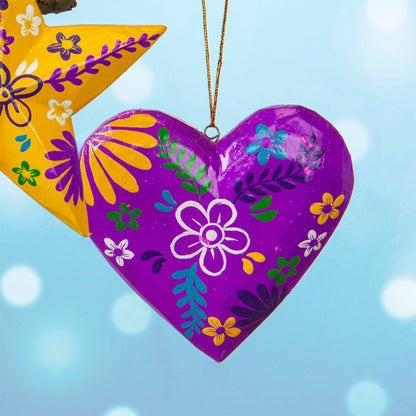 Magenta hand-painted wood heart hanging with white and yellow floral motifs, Bali Indonesia, with yellow star in background
