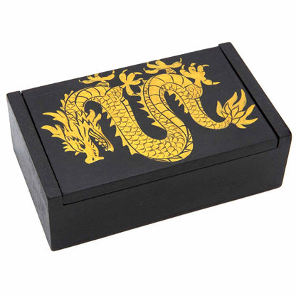 Black wooden dragon box three-quarter view showing gold coiling dragon with scales and flames painted on lid, Indonesia