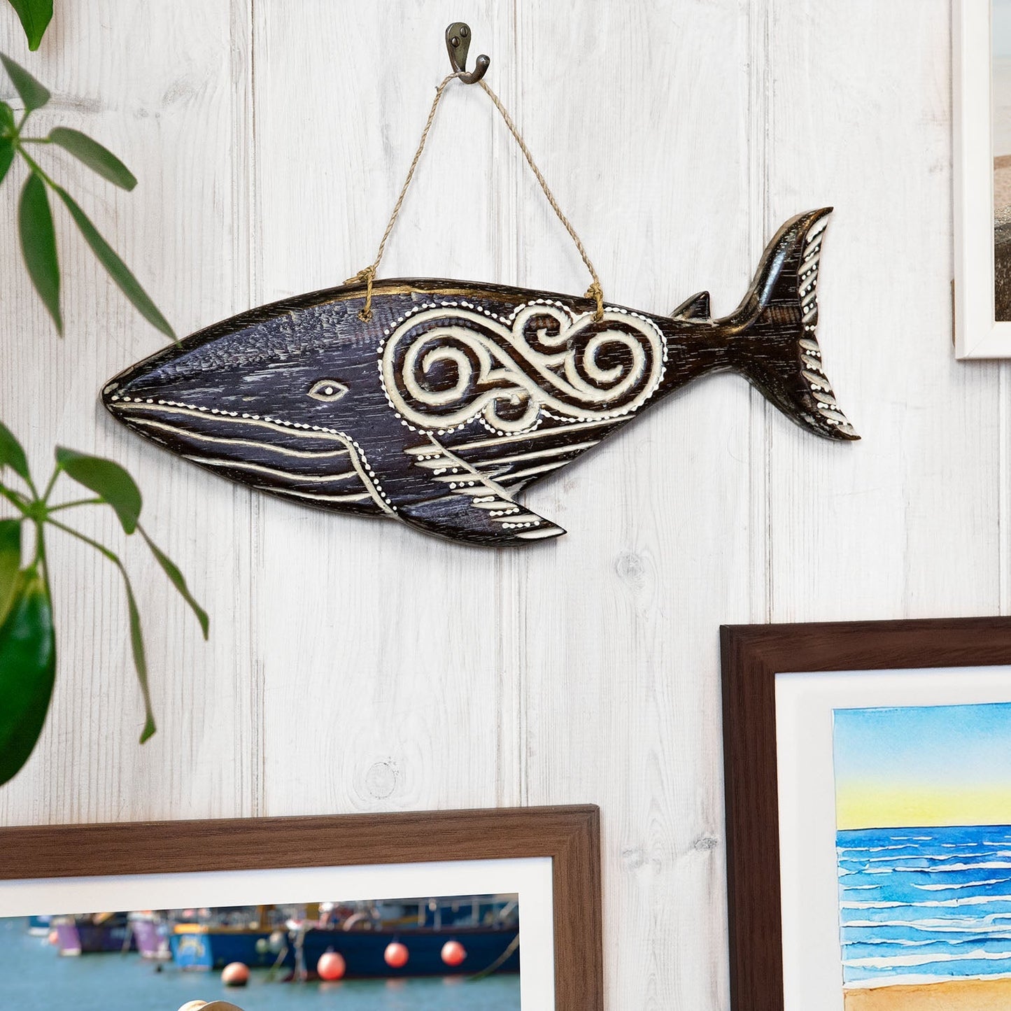 Hand-carved wooden whale plaque with tribal-style relief carving, made by artisans in Bali, Indonesia