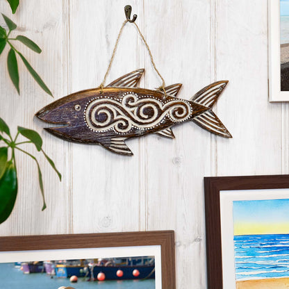 Hand-carved wooden fish plaque with flowing tribal-style relief carving, made by artisans in Bali, Indonesia