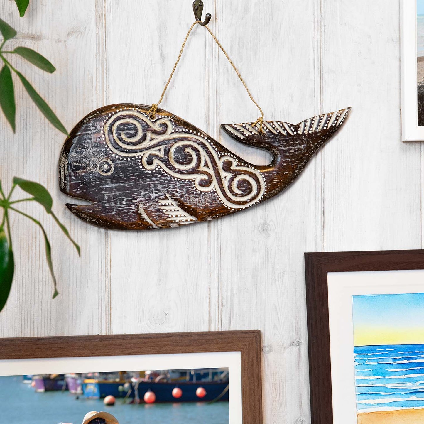 Round hand-carved wooden whale plaque with wave-like tribal-style relief carving, made by artisans in Bali, Indonesia