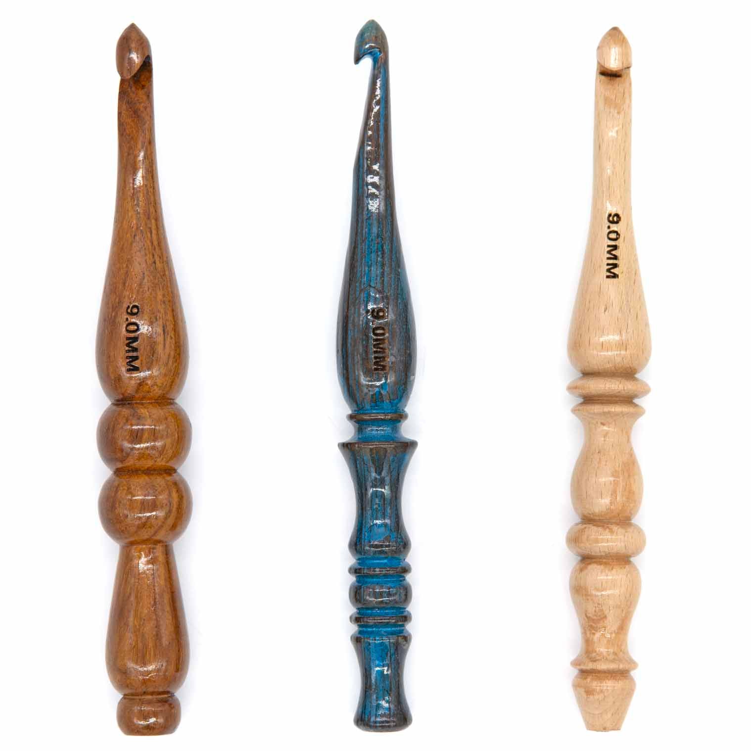 Three 9mm wooden crochet hooks: dark ringed turned handle, blue-painted turned handle, and pale baluster-profile handle