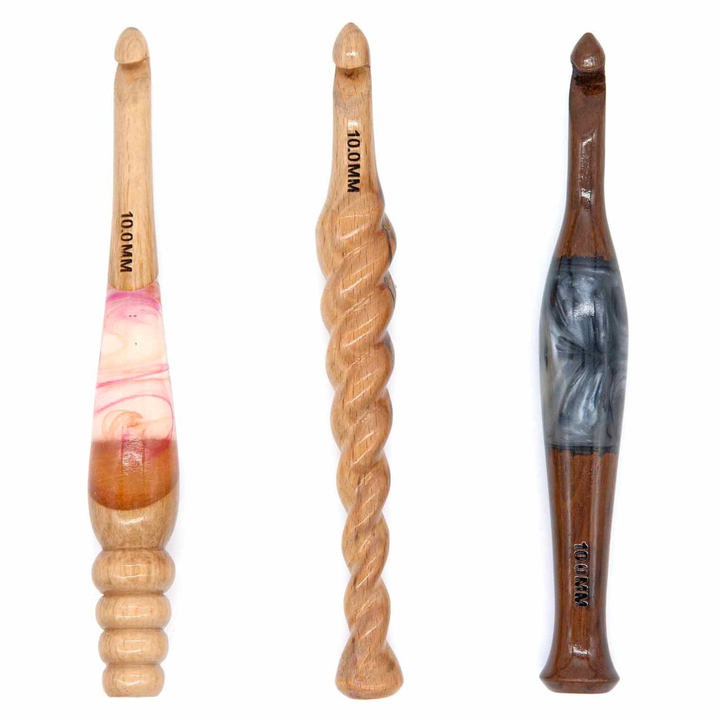 Three 10mm wooden crochet hooks: pale wood with pink resin inlay, twisted-rope turned handle, dark wood with grey resin inlay