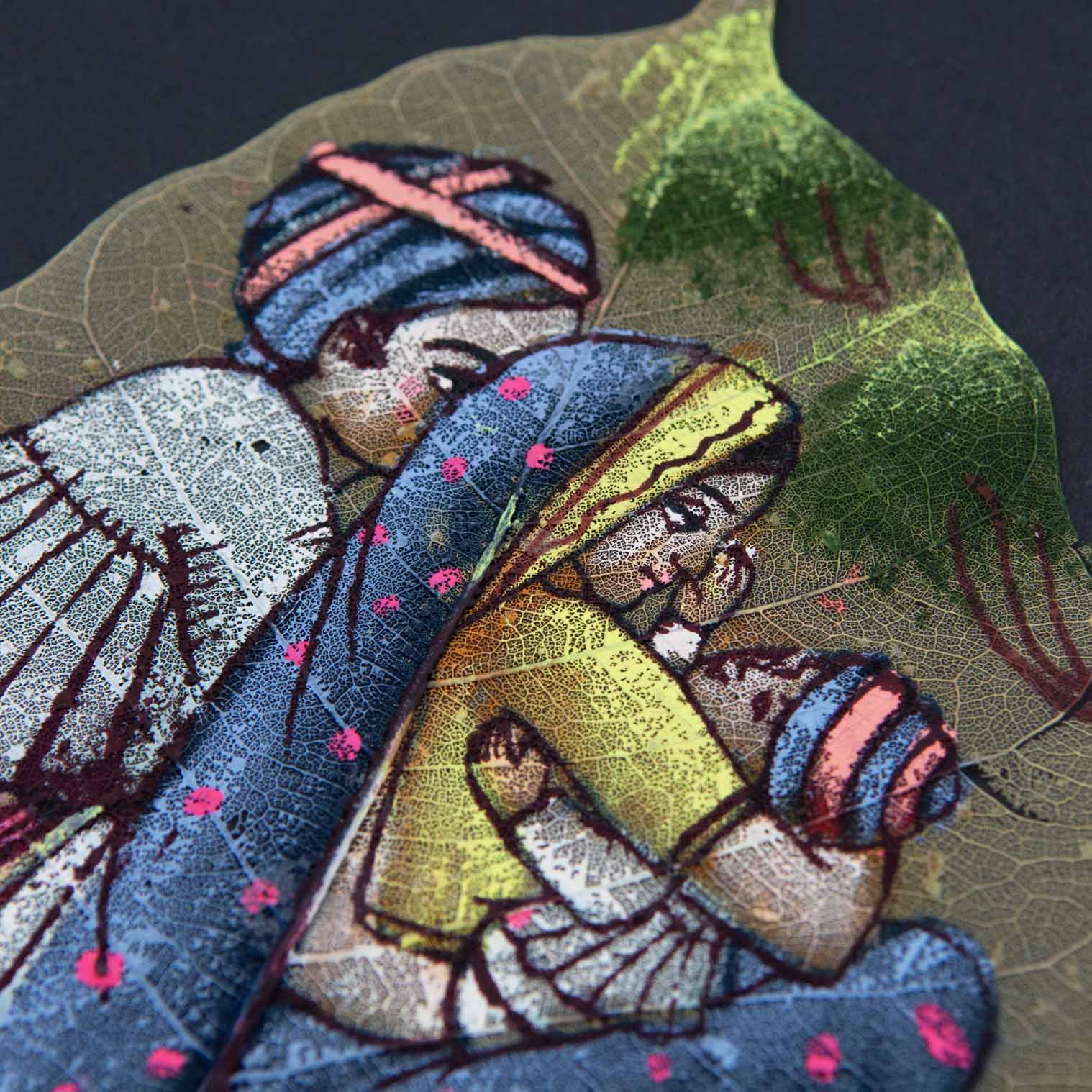 Close-up of peepal leaf painting showing fine brushwork and leaf vein detail in family scene, India