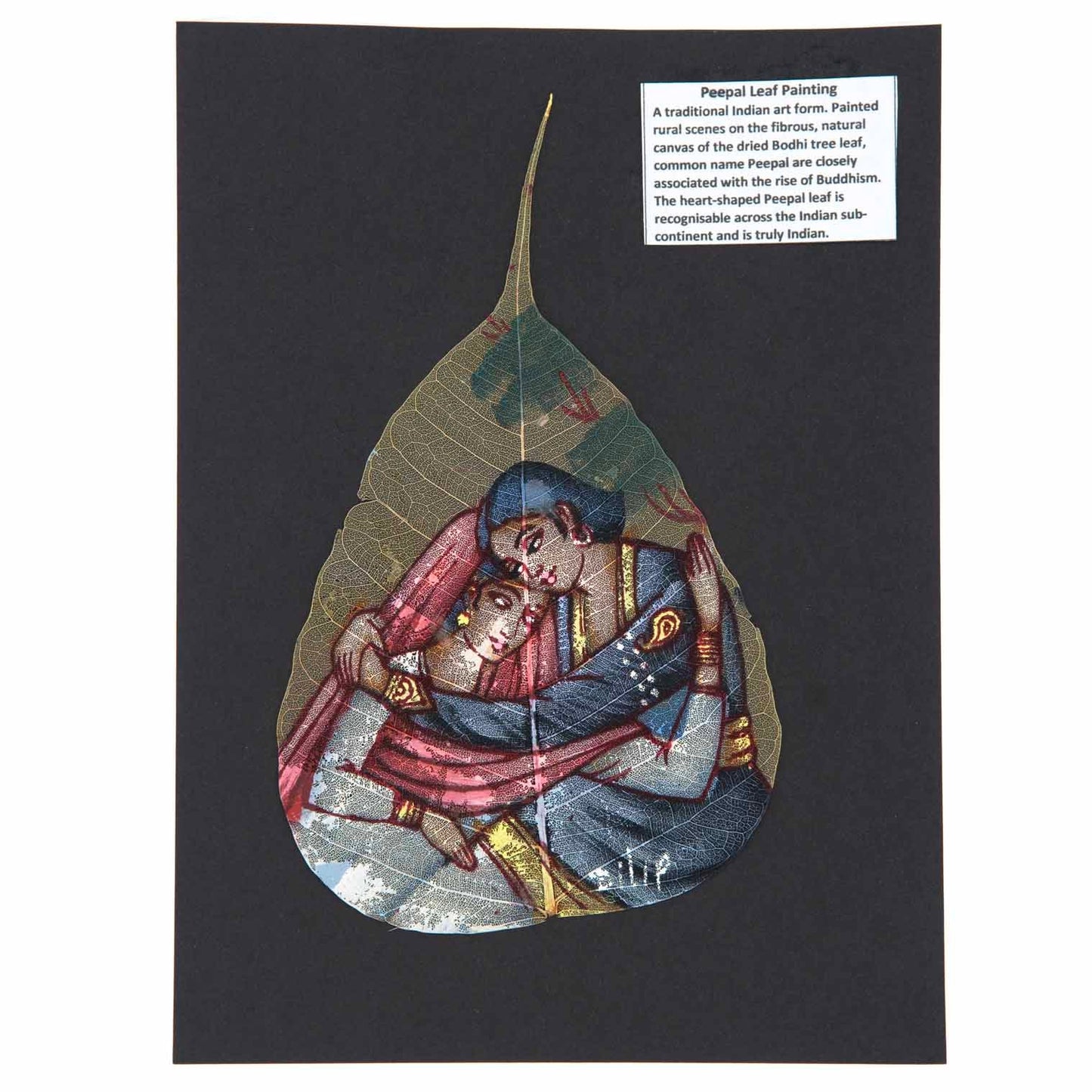 Hand-painted peepal leaf showing Indian miniature lovers scene in red, blue and gold, mounted on dark card, India