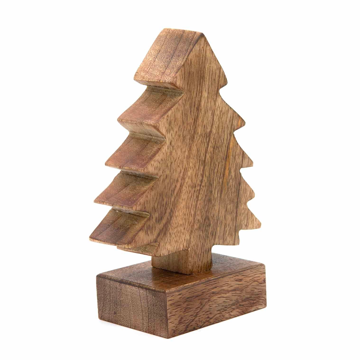 Small carved mango wood Christmas tree, three-quarter angle showing stepped branch profile and grain