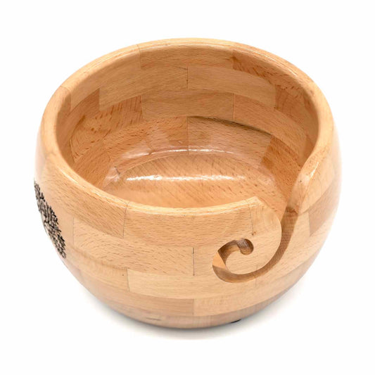 Segmented wood yarn bowl angled to show carved spiral slot in rim and engraved tree detail, India