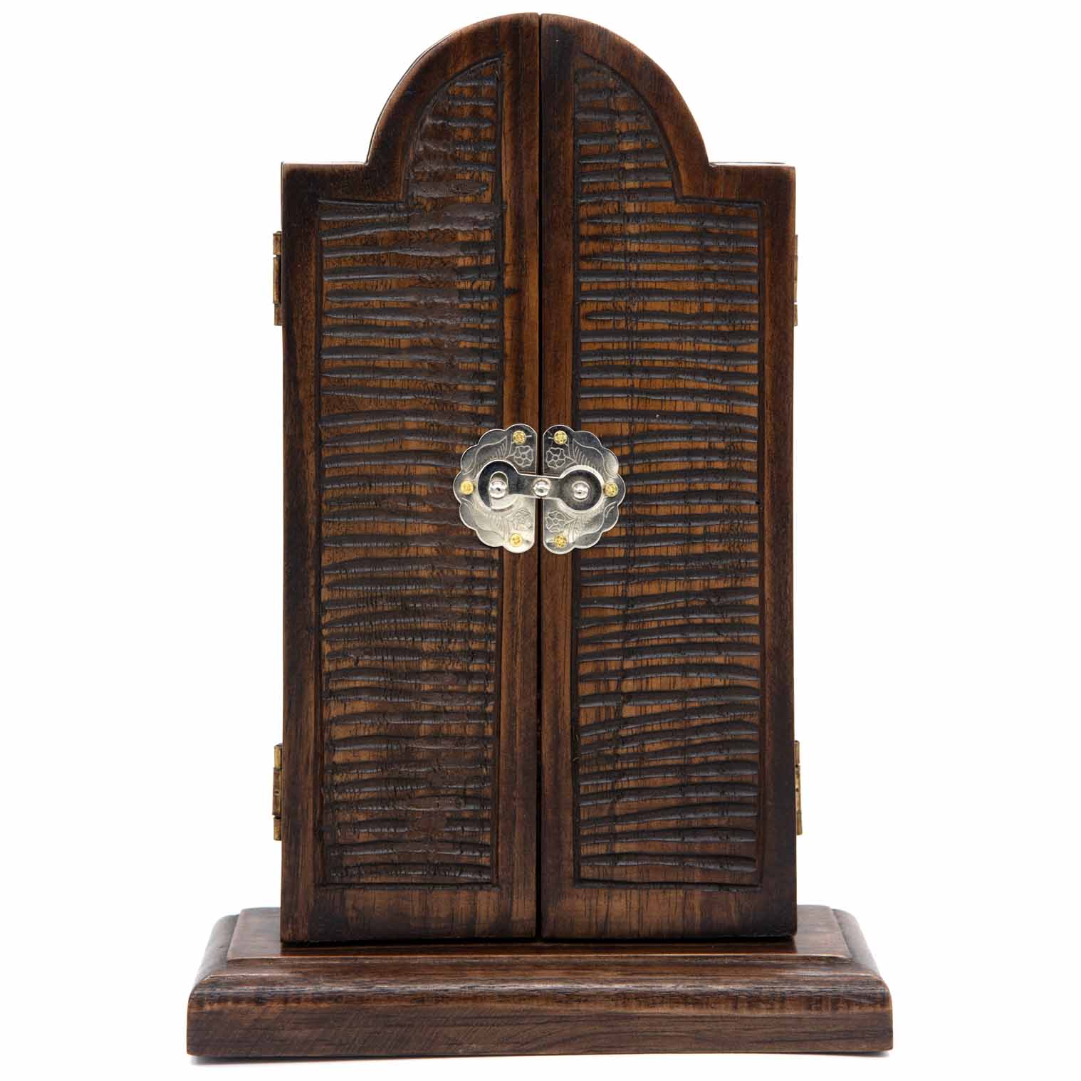 Cedar triptych closed, front view showing textured chisel-marked doors and metal clasp