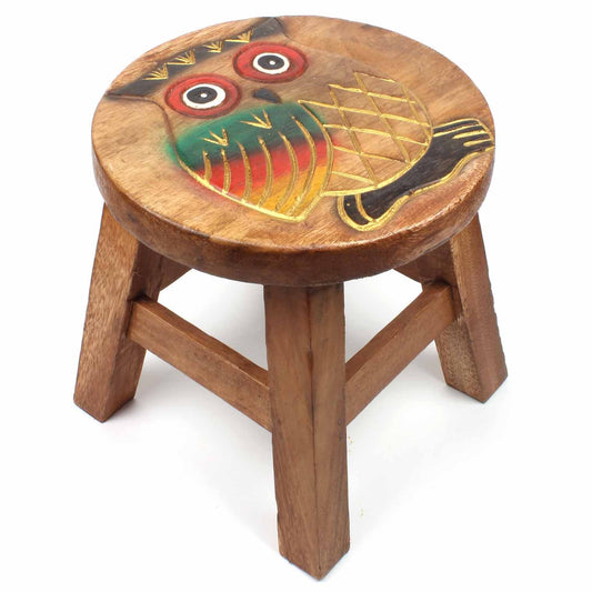Carved owl stool in Raintree wood on white background, showing teal and red wing detail and cross-hatched chest carving