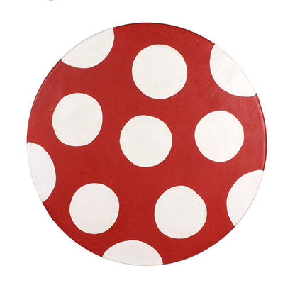 Top-down view of Raintree wood mushroom stool seat showing red paint and bold white spot pattern, northern Thailand