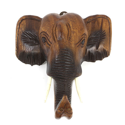 Carved Raintree elephant head wall mount, front view showing raised trunk and tusks, white background, Thailand
