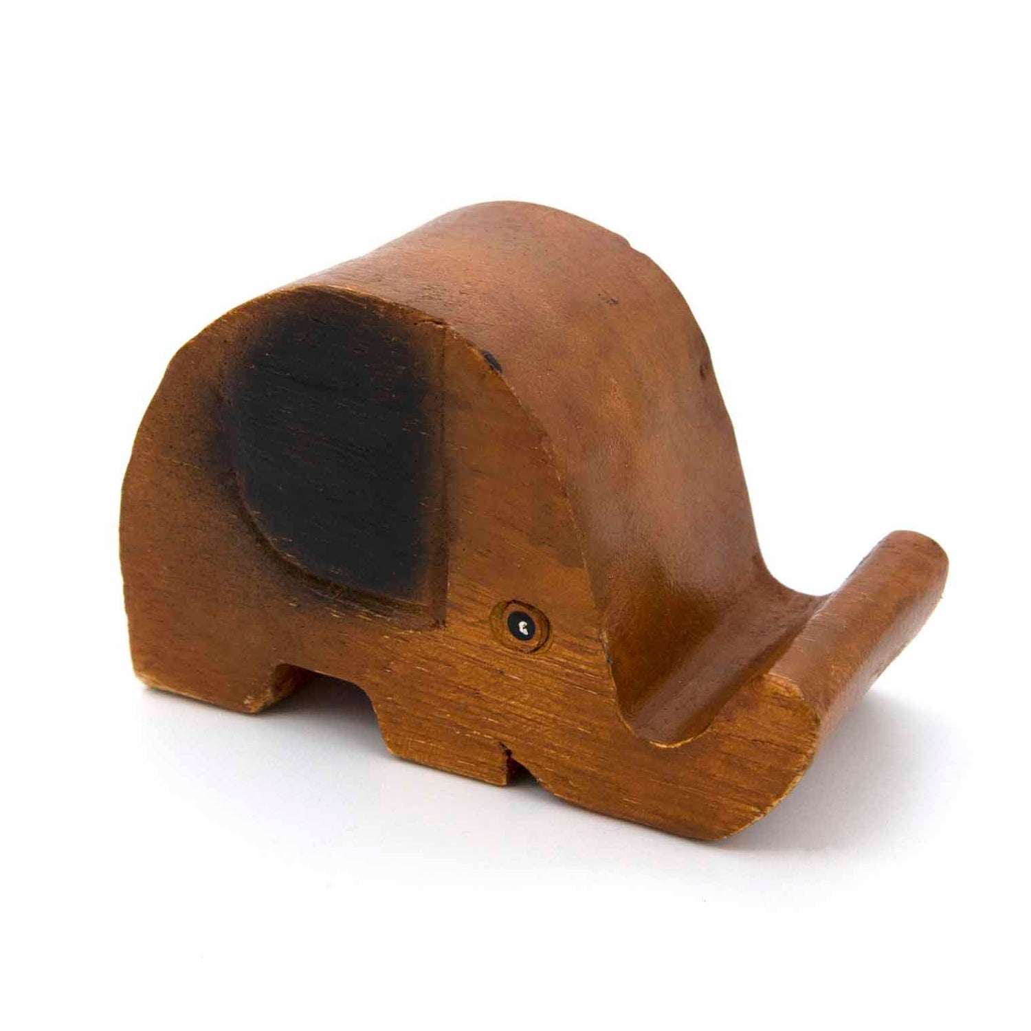 Carved hardwood elephant phone stand without phone, three-quarter view showing trunk cradle, white background