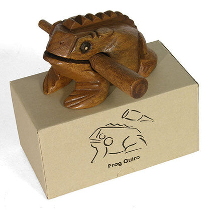 Rain Tree wood frog guiro sitting on top of its printed kraft cardboard box with striker