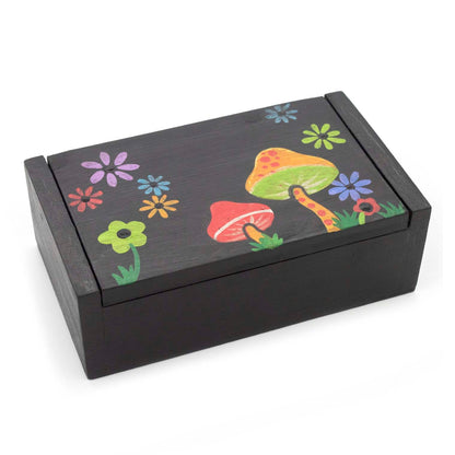 Black wooden box with mushroom and flower painted lid, three-quarter view on white