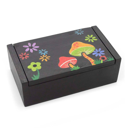 Black wooden box with mushroom and flower painted lid, three-quarter view on white