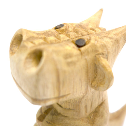 Hand-carved wooden smoking dragon incense burner, a seated dragon with scaled back, clawed feet and curled tail, smoke channels carved through the nostrils